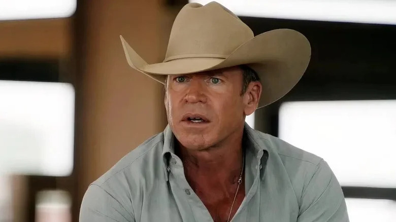 Taylor Sheridan's Travis Wheatley wearing a cowboy hat and looking surprised on Yellowstone