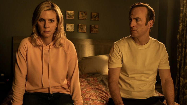 Rhea Seehorn as Kim sitting on the edge of a bed next to Bob Odenkirk as Jimmy in Better Call Saul