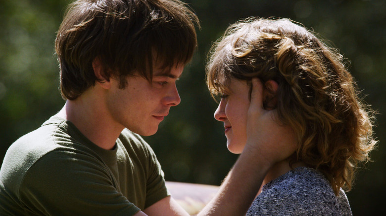 Charlie Heaton and Natalia Dyer as Jonathan and Nancy crying while facing each other in Stranger Things