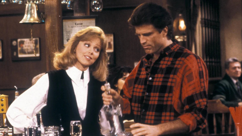 Shelley Long as Diane looking at Ted Danson as Sam behind the bar in Cheers