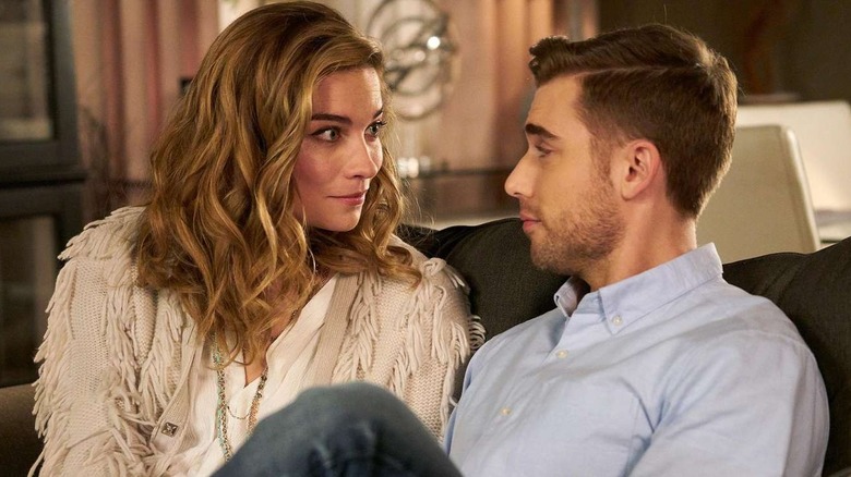 Annie Murphy as Alexis looking at Dustin Milligan as Ted in Schitt's Creek