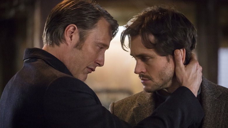 Mads Mikkelsen as Dr. Hannibal Lecter and Hugh Dancy as Will Graham, standing close to each other in Hannibal.