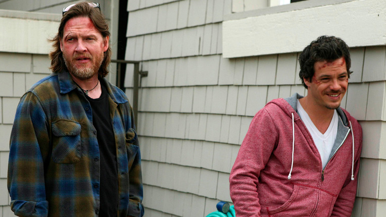 Donal Logue as Henry "Hank" Dolworth and Michael Raymond-James as Britt Pollack, standing outside a house in Terriers.