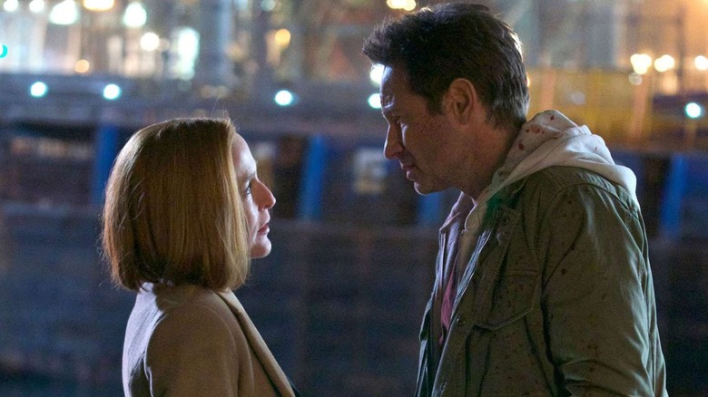 Gillian Anderson as Scully looking up at David Duchovny as Mulder in The X-Files