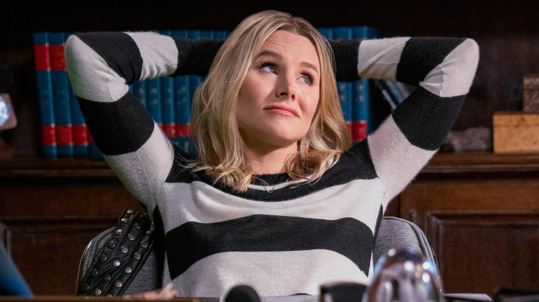 Kristen Bell as Veronica Mars leaning back at a desk in Veronica Mars
