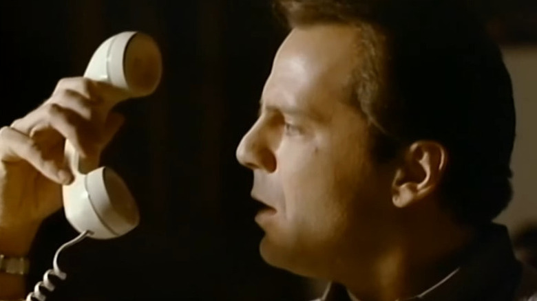 Peter Novins (Bruce Willis) stares incredulously at a phone in The Twilight Zone (1985)