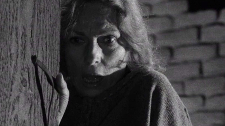 A woman (Agnes Moorehead) stands shocked against a wooden beam in The Twilight Zone (1959)