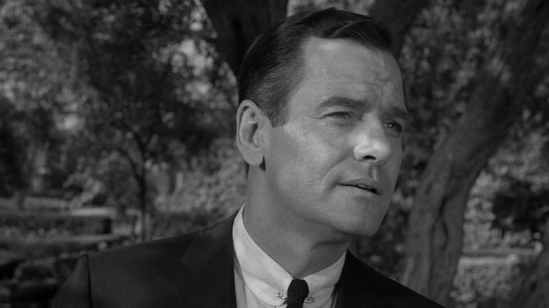Martin Sloan (Gig Young) leans slightly forward while standing outside in The Twilight Zone (1959)