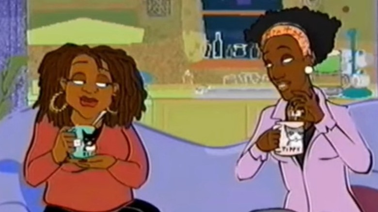 Yvette and Monie sitting on the couch and holding tea cups on Hey Monie! S2E7