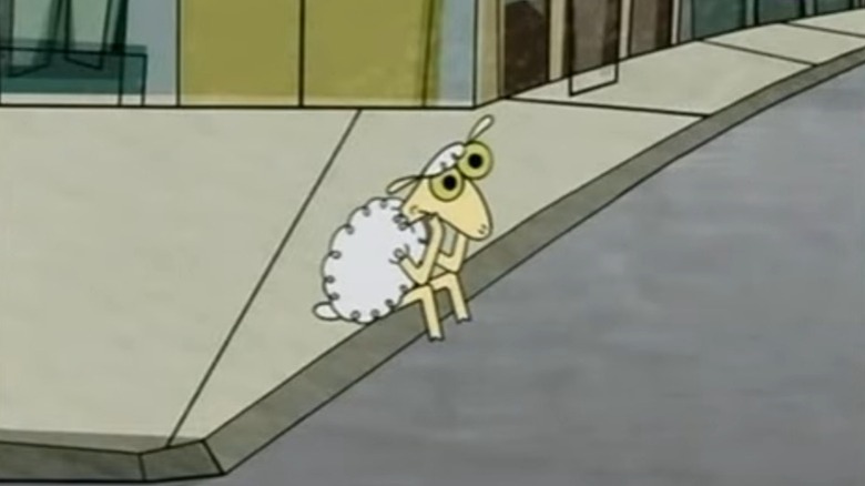 Sheep sitting on a sidewalk and holding his face in his hands on Sheep in the Big City S1E1