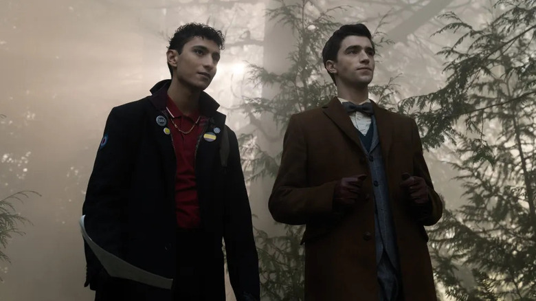 Charles Rowland (Jayden Revri) and Edwin Payne (George Rexstrew) standing in a forest on "Dead Boy Detectives."