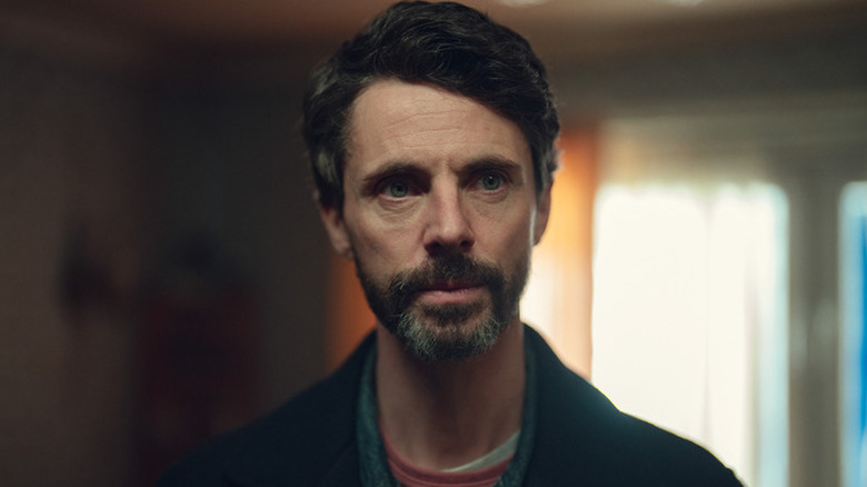 Carl Morck (Matthew Goode) standing inside a house on "Dept. Q"