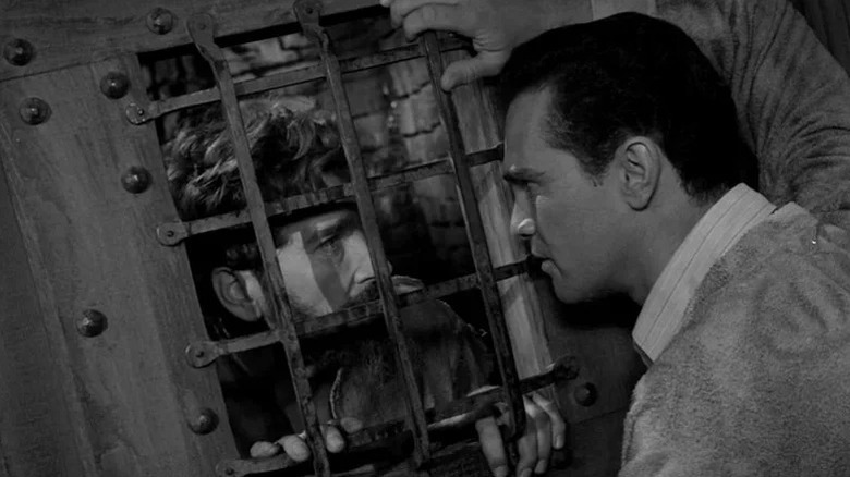 David looking at The Howling Man through a cell