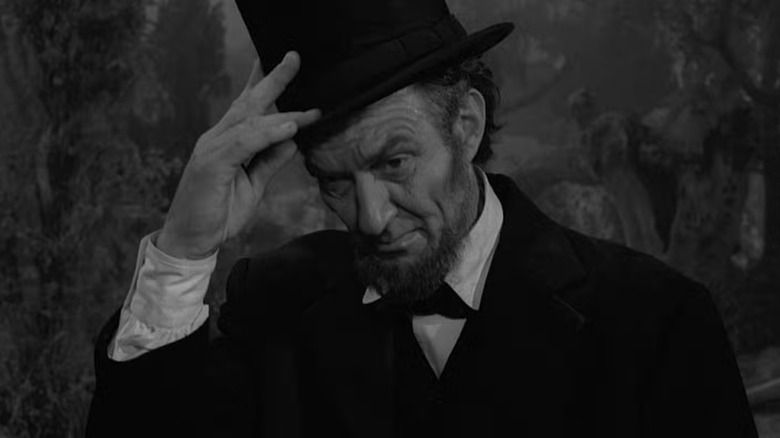 Abraham Lincoln holding his hat
