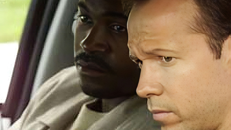 Mykelti Williamson as Detective Smith sits next to Donnie Wahlberg as Detective Stevens in Boomtown