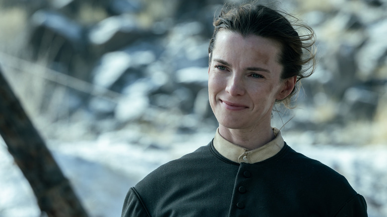 Betty Gilpin as Sara smiling outside in American Primeval