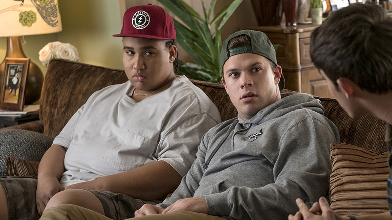 Lou Wilson and Jimmy Tatro as Lucas and Dylan sitting on a couch in American Vandal