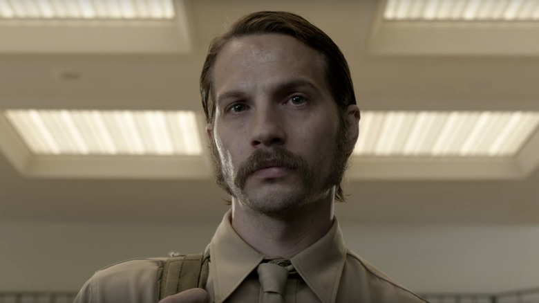 Mac Conway (Logan Marshall-Green) standing in a lit room on "Quarry."