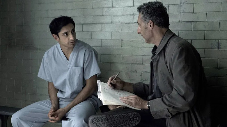 Nasir (Riz Ahmed) and John (John Turturro) sitting in a cell on "The Night Of."