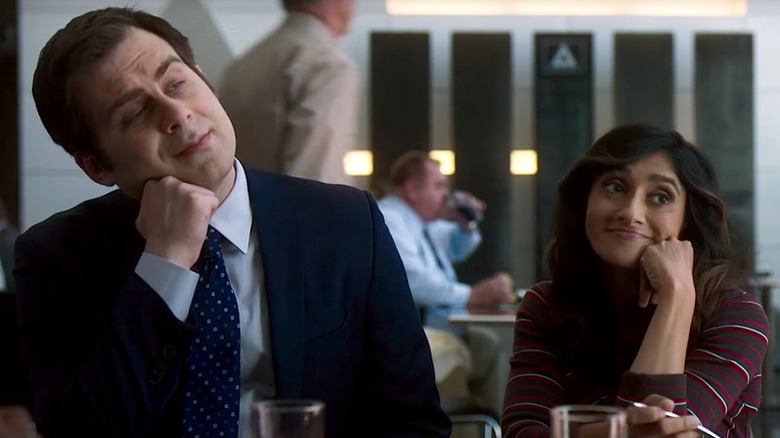 Jake Weisman as Jake leaning on fist next to Aparna Nancherla as Grace doing the same pose in Corporate