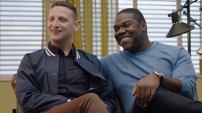 Tim Robinson as Tim and Sam Richardson as Sam sitting next to each other smiling in Detroiters