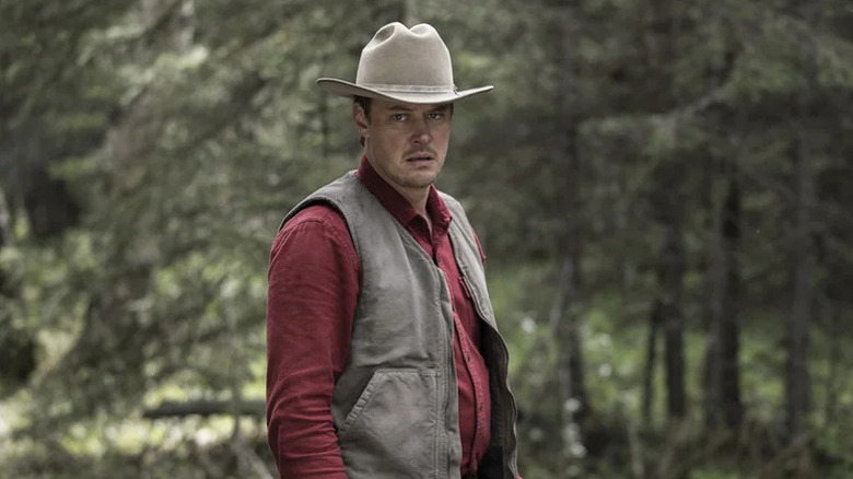 Michael Dorman in red shirt and cowboy hat as Joe Pickett in Joe Pickett