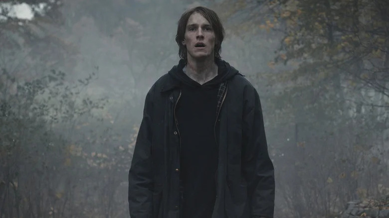 Jonas Kahnwald (Louis Hofman) stands in a foggy forest in Dark
