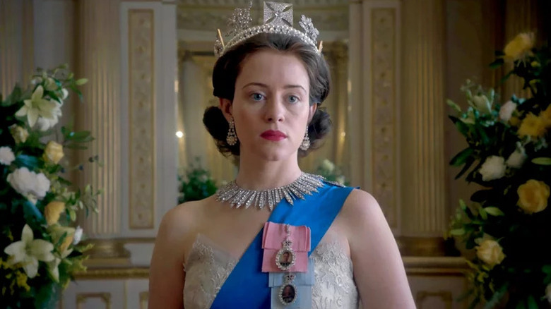 Queen Elizabeth II (Claire Foy) stands stoically at a formal ceremony in The Crown