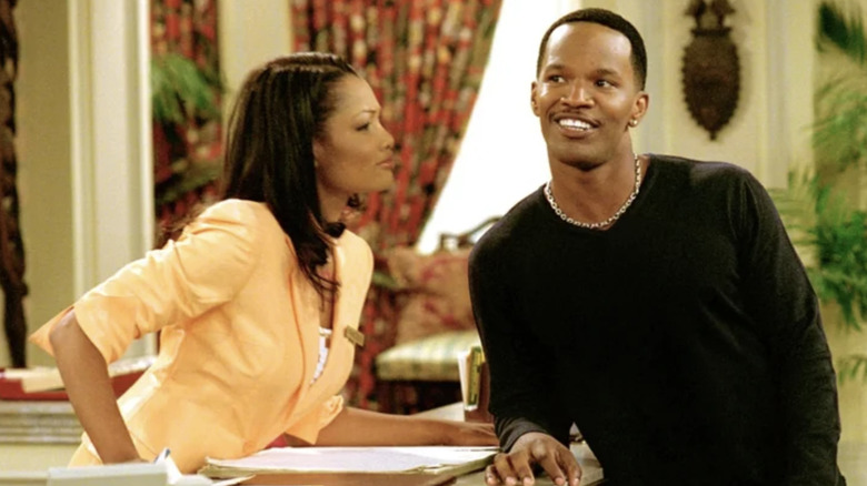 Fancy Monroe (Garcelle Beauvais) listens to Jamie King (Jamie Foxx) on The Jamie Foxx Show