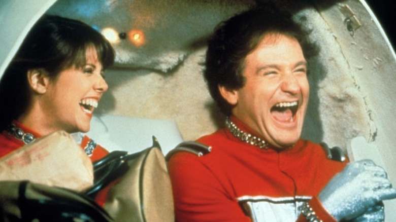 Mindy (Pam Dawber) and Mork (Robin Williams) ride a spaceship on Mork & Mindy