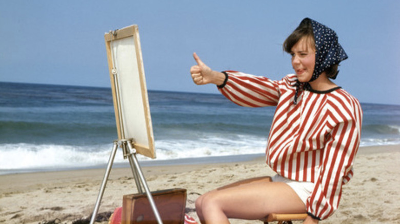 Gidget (Sally Field) paints on the beach on Gidget