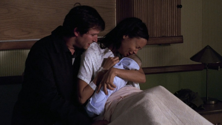 Noah Wyle as Carter and Thandiwe Newton as Kem holding newborn and crying in "ER."