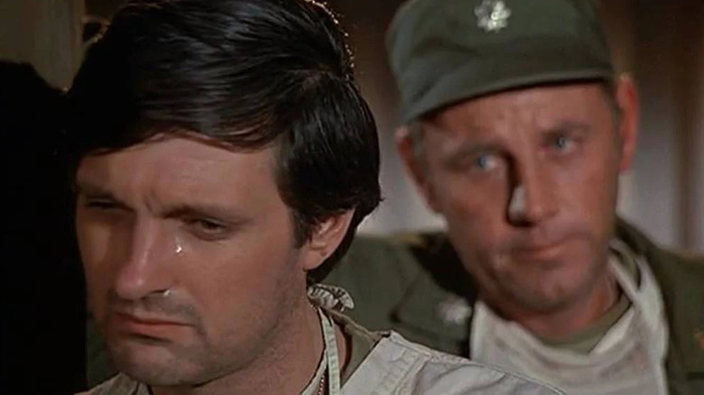 Hawkeye Pierce (Alan Alda) cries as Henry Blake (McLean Stevenson) comforts him in M*A*S*H