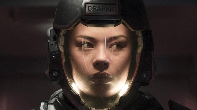Bobbie Draper (Frankie Adams) has her face illuminated in a spacesuit in The Expanse