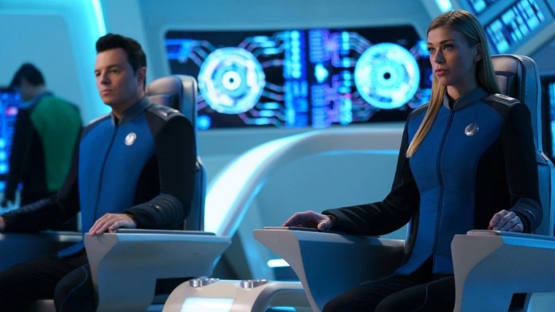 Ed Mercer (Seth MacFarlane) and Kelly Grayson (Adrianne Palicki) sit in their command chairs on the ship's bridge in The Orville