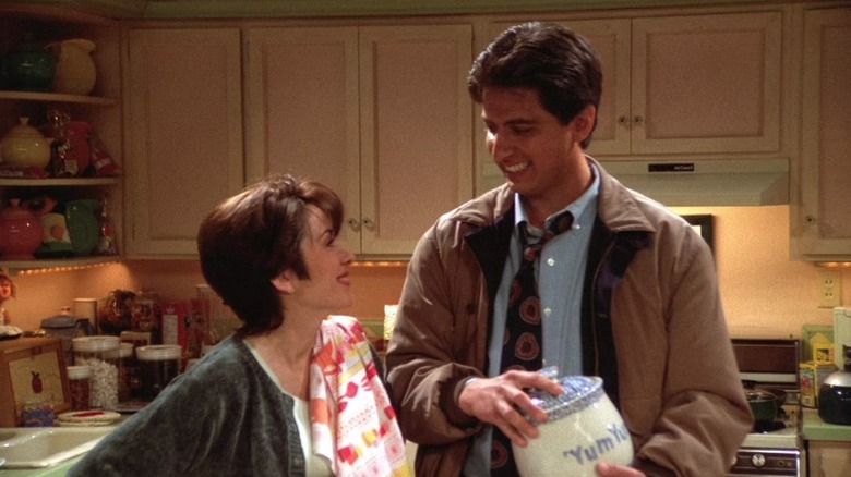 Debra and Ray smiling at each other in the kitchen on Everybody Loves Raymond