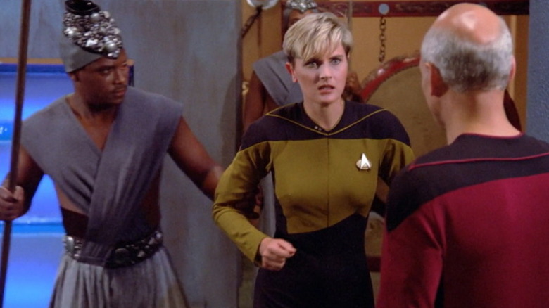 A guard leads Tasha Yar (Denise Crosby) away as Jean-Luc Picard (Patrick Stewart) watches in Star Trek: The Next Generation