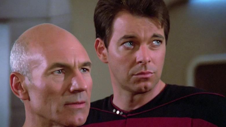 Jean-Luc Picard (Patrick Stewart) and Will Riker (Jonathan Frakes) stare intently at a viewscreen in Star Trek: The Next Generation