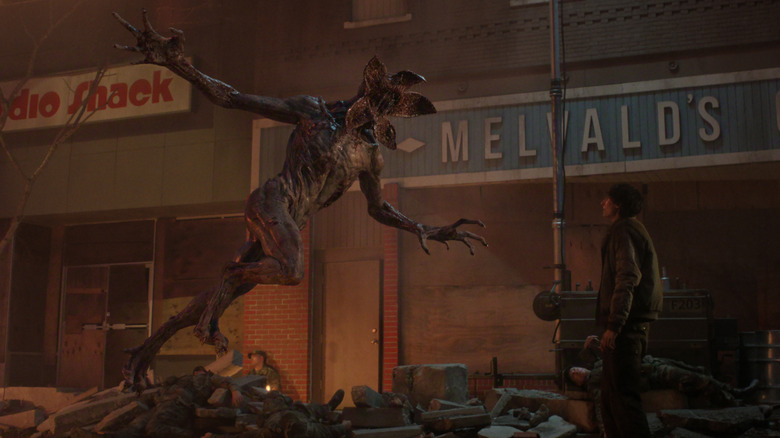 A Demogorgon charges at Finn Wolfhard's Mike on Stranger Things.