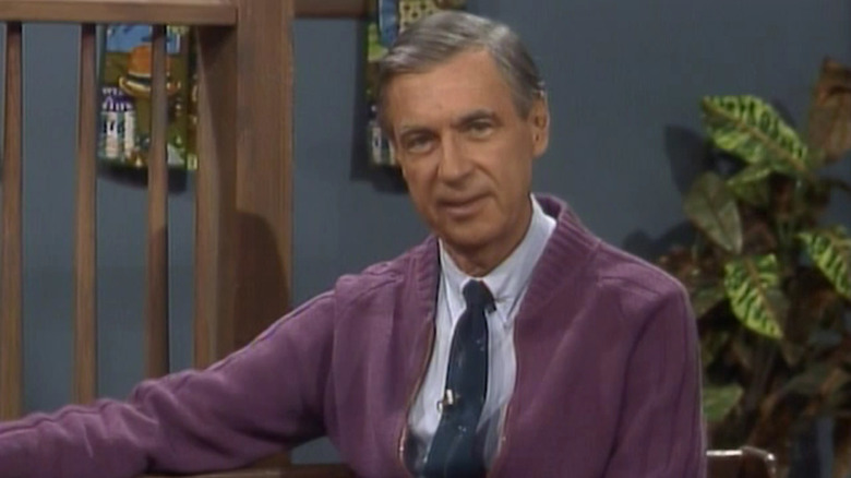 Fred Rogers in purple sweater and blue tie on Mister Rogers' Neighborhood