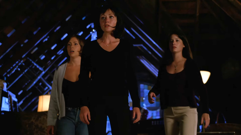 Alyssa Milano's Phoebe, Shannen Doherty's Prue, and Holly Marie Comb's Piper Halliwell standing together in Charmed