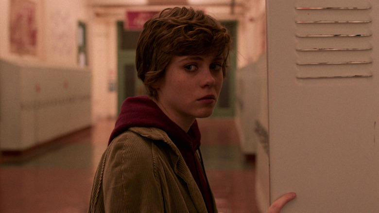 Sophia Lillis as Sydney looking to the side with her locker open in I Am Not Okay With This