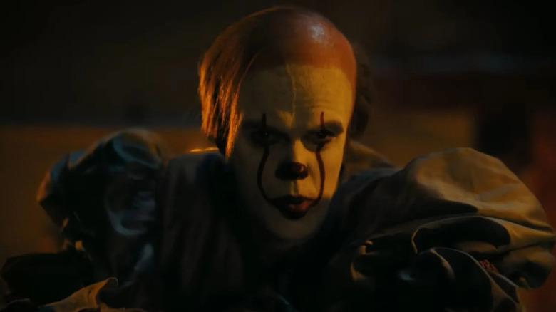 Bill Skarsgard as Bob Gray in Pennywise makeup in It: Welcome to Derry