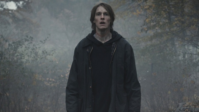 Jonas Kahnwald (Louis Hofman) stands in a foggy forest in Dark