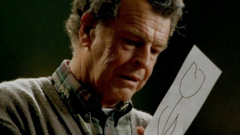 Walter Bishop (John Noble) holds a drawing of a flower in Fringe