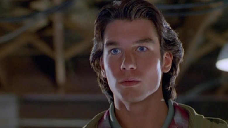 Quinn Mallory (Jerry O'Connell) stands staring intensely in Sliders