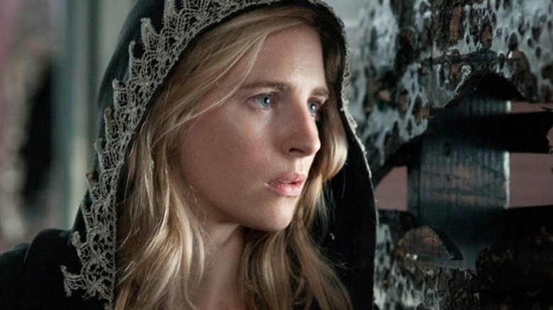 Prairie Johnson (Brit Marling) stands next to a wall in The OA