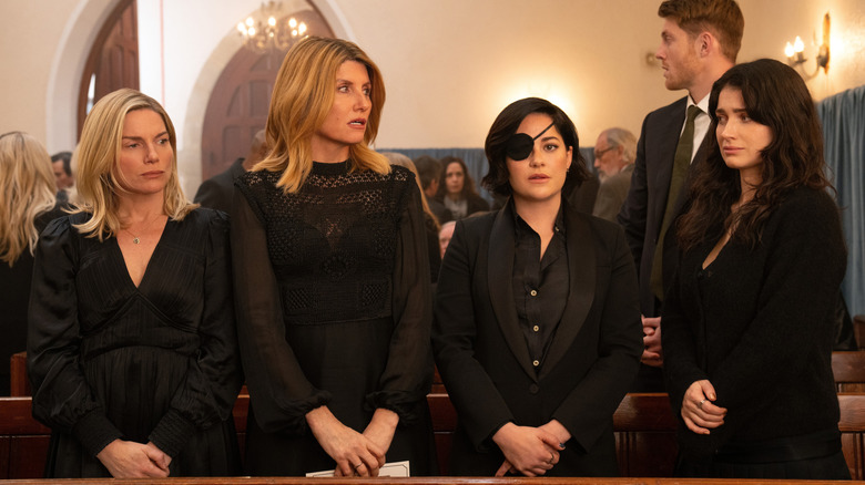 Eva, Ursula, Bibi, and Becka, standing in a church pew on Bad Sisters.