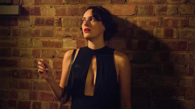 Fleabag, leaning against a wall and smoking in Fleabag.
