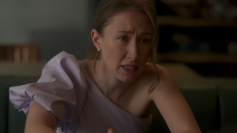 Erin Doherty in purple dress looking distressed as Becky in Chloe